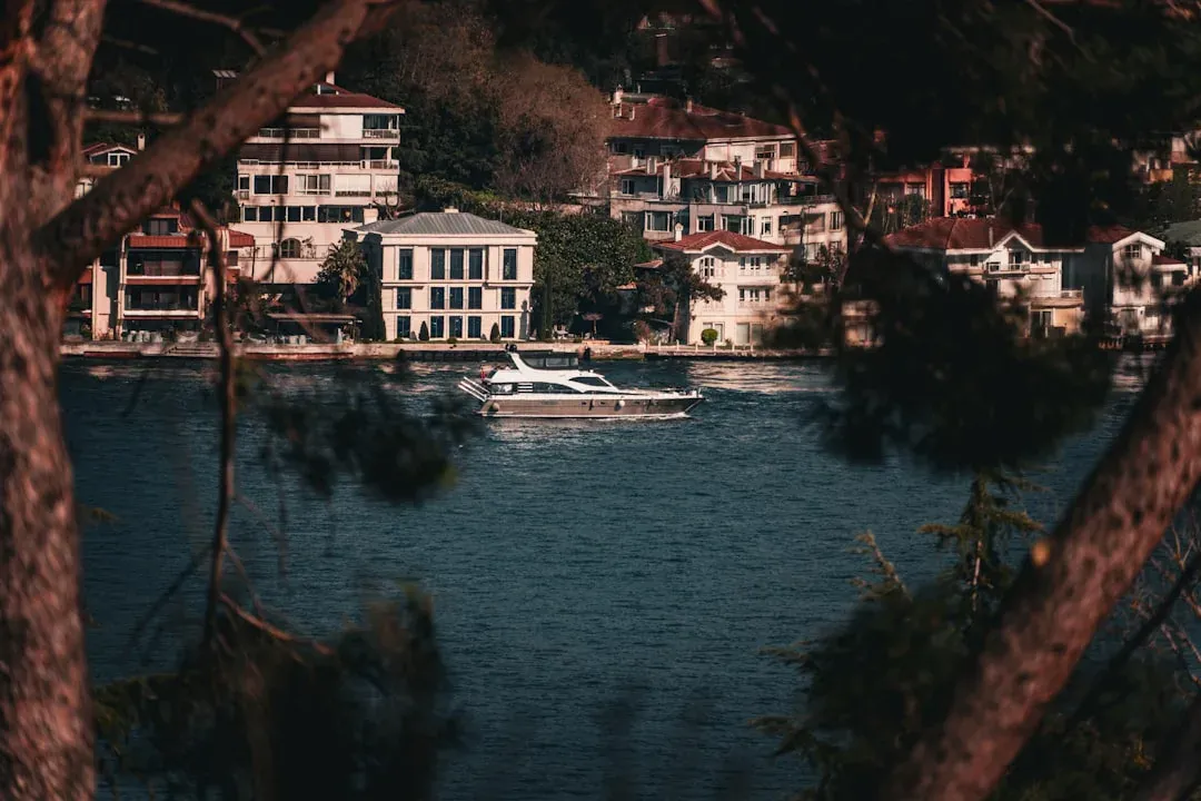 a sailboat gliding across the bosphorus with the city skyline